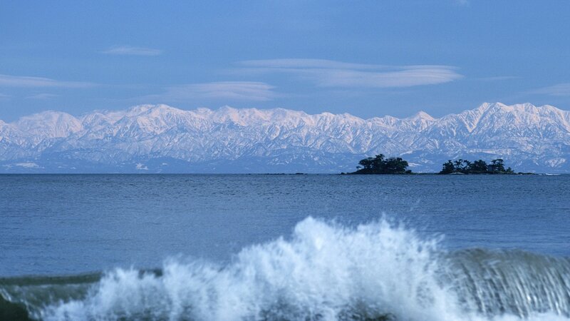 Snow-capped mountains and ocean waves
