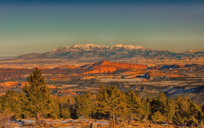 snow-capped mountains and red rock formations