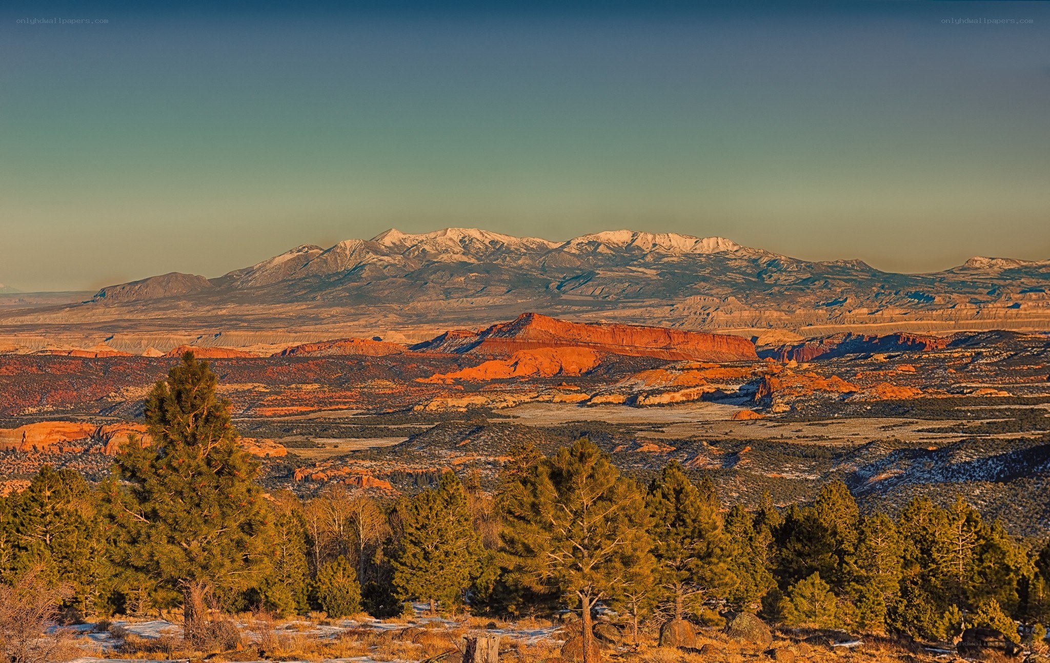 snow-capped mountains and red rock formations