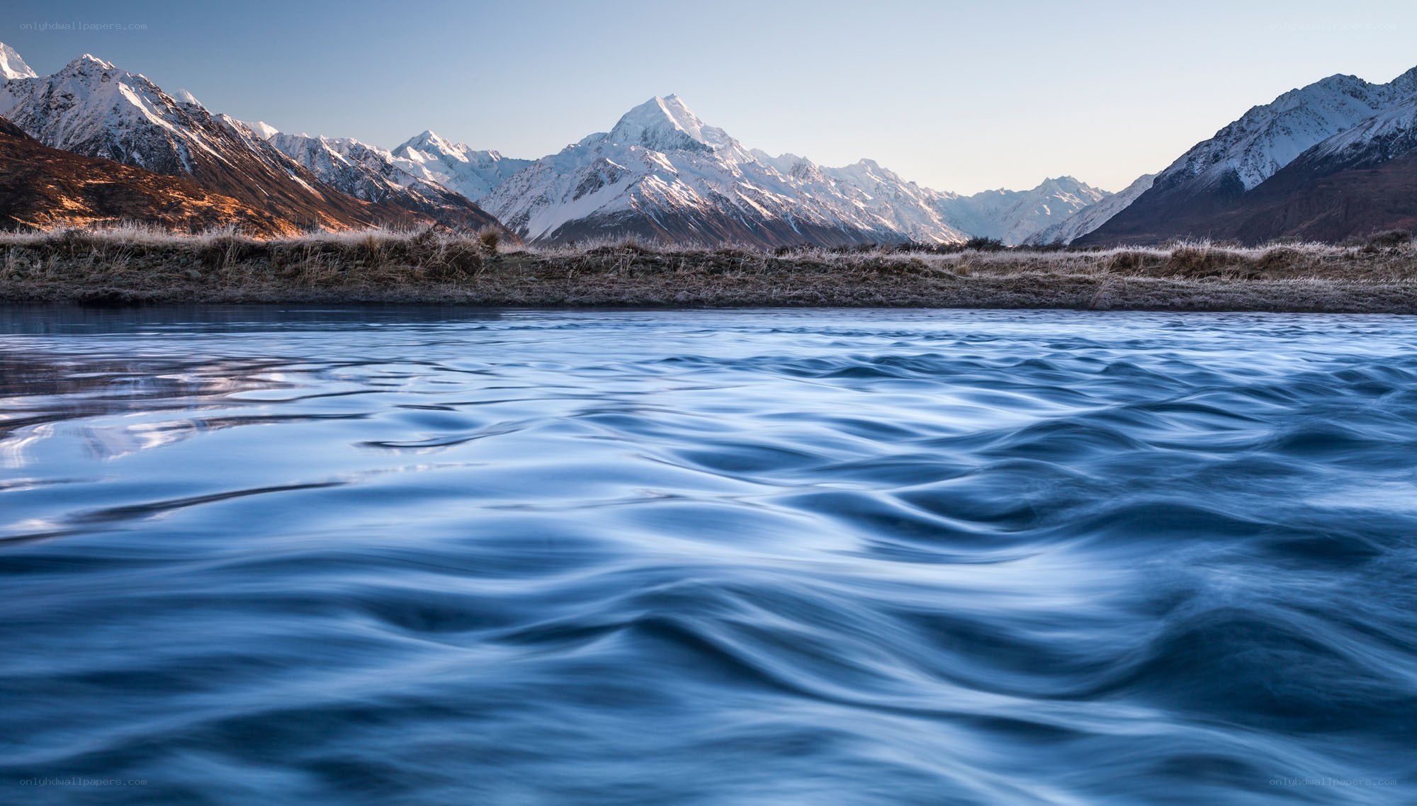 Snow-capped mountains and river