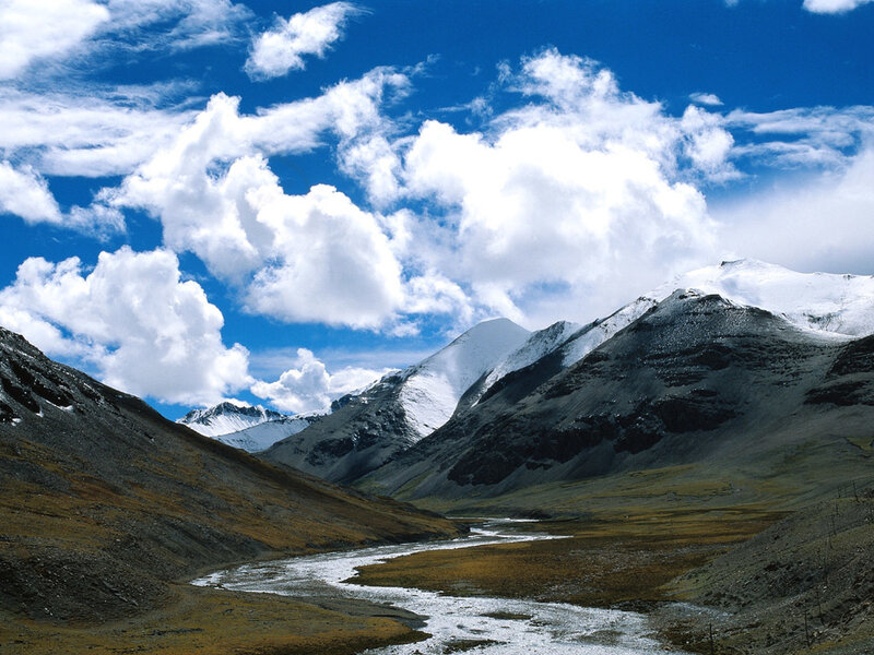 Snow-capped mountains and river valley