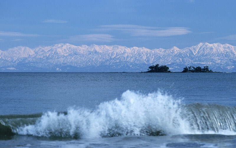 Snow-capped mountains and sea waves