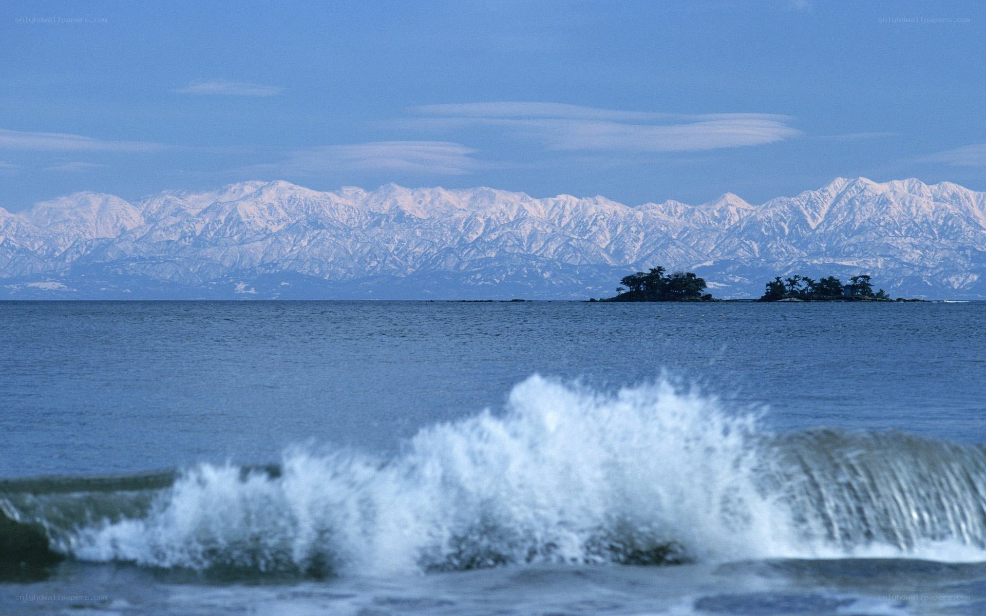 Snow-capped mountains and sea waves