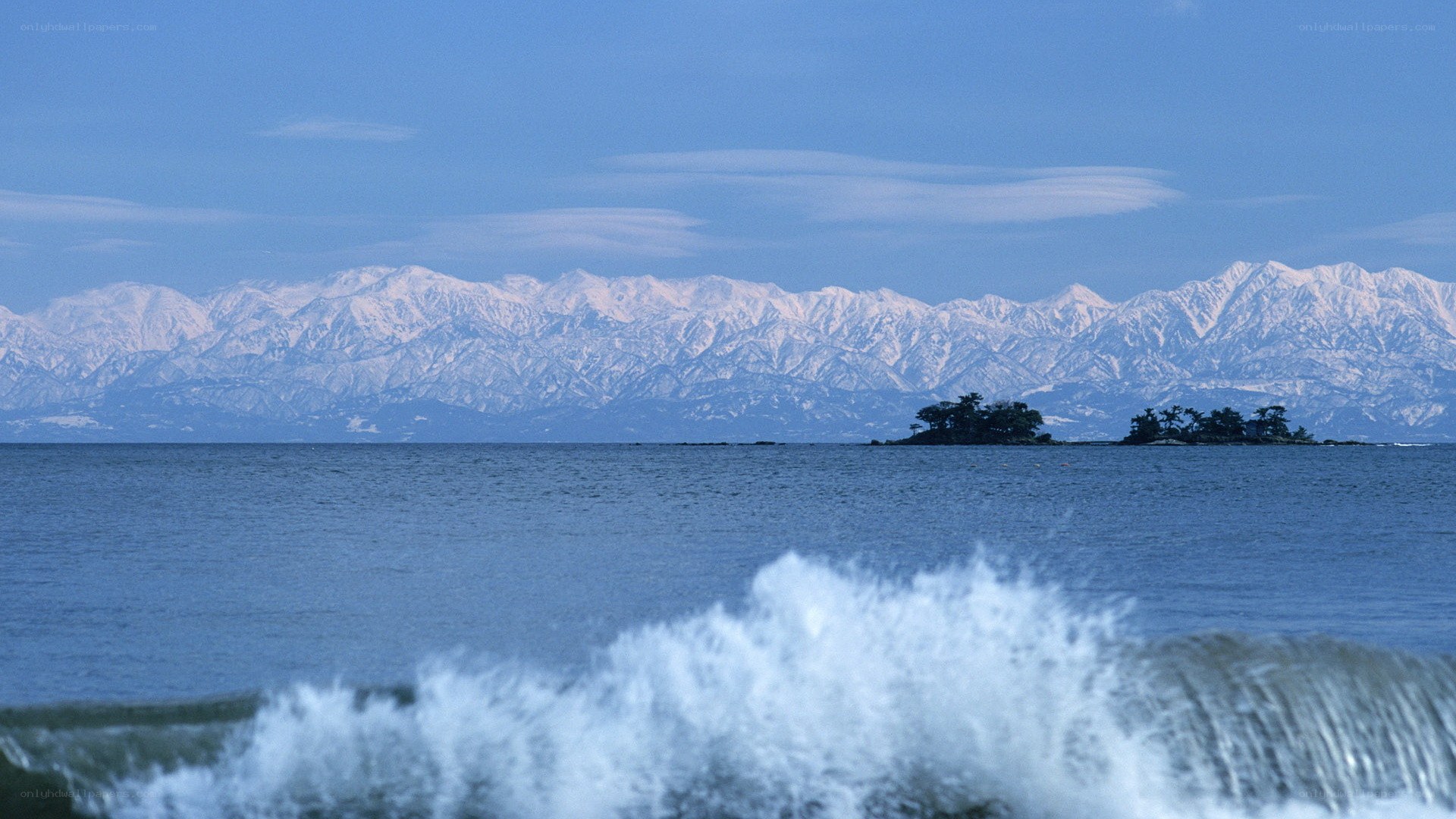Snow-capped mountains and sea waves