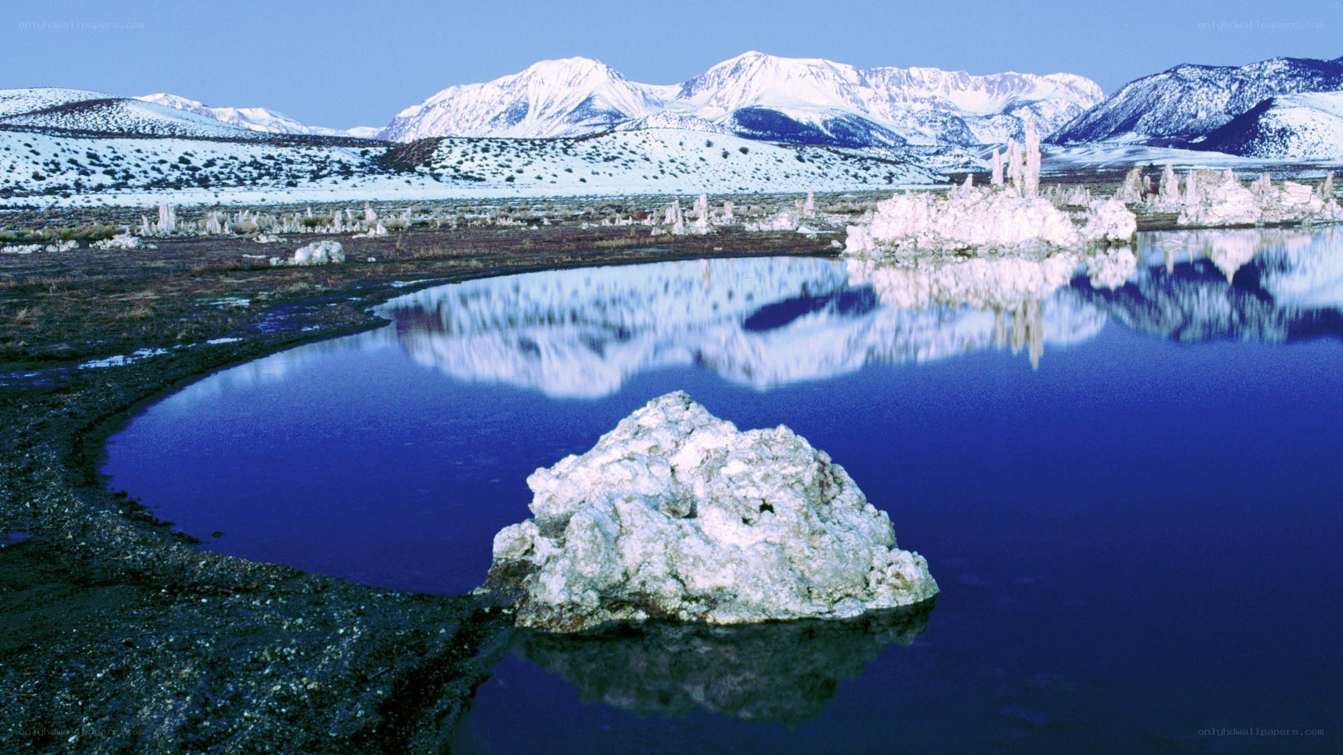 Snow-capped mountains and tufa formations