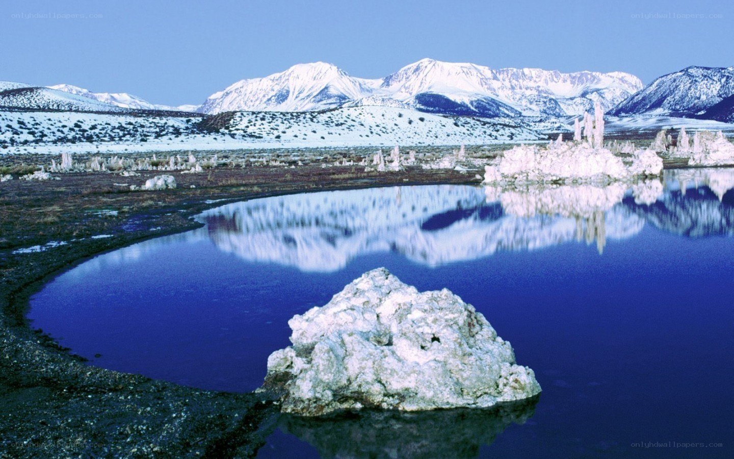 Snow-capped mountains and tufa formations