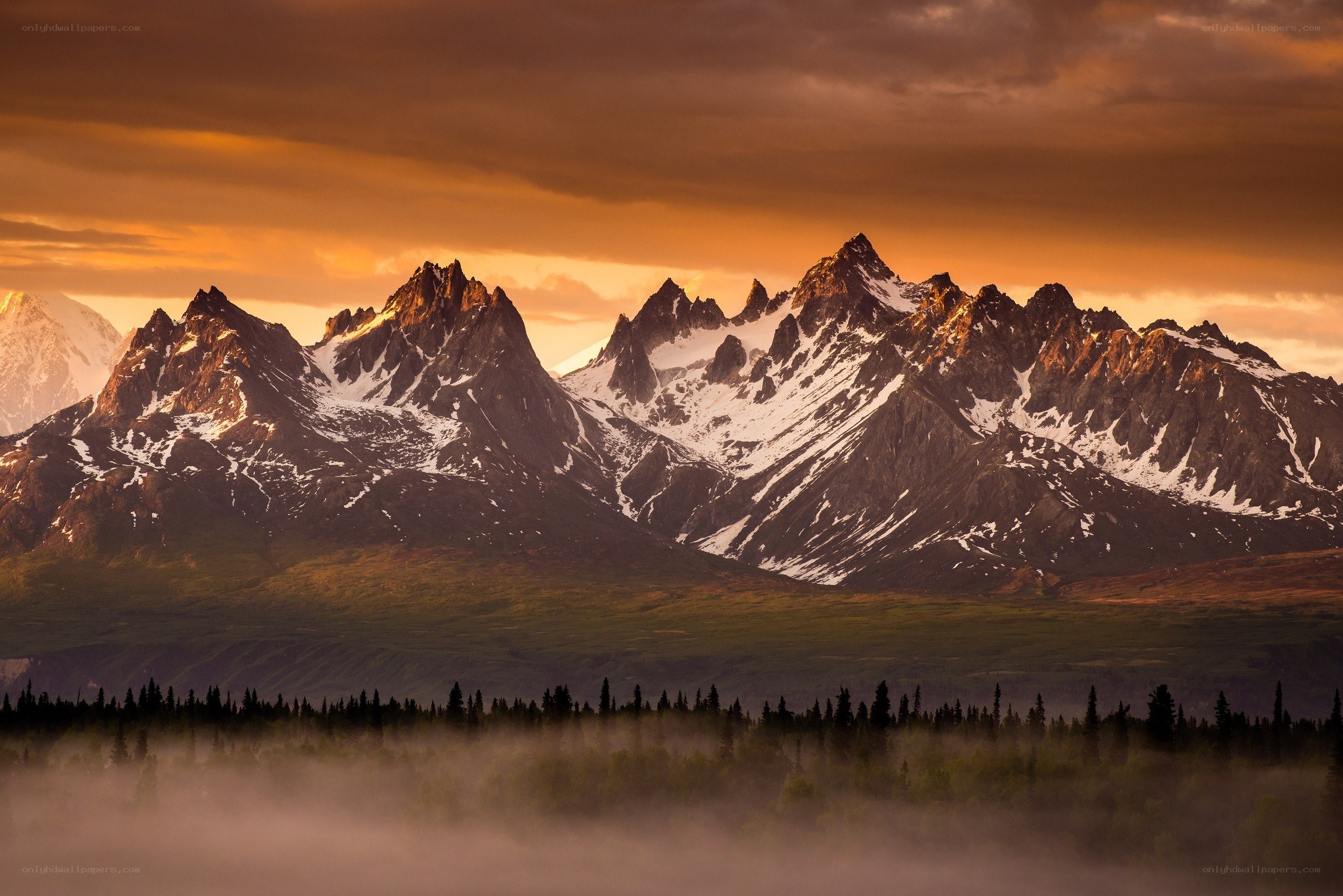 Snow-capped mountains at sunrise