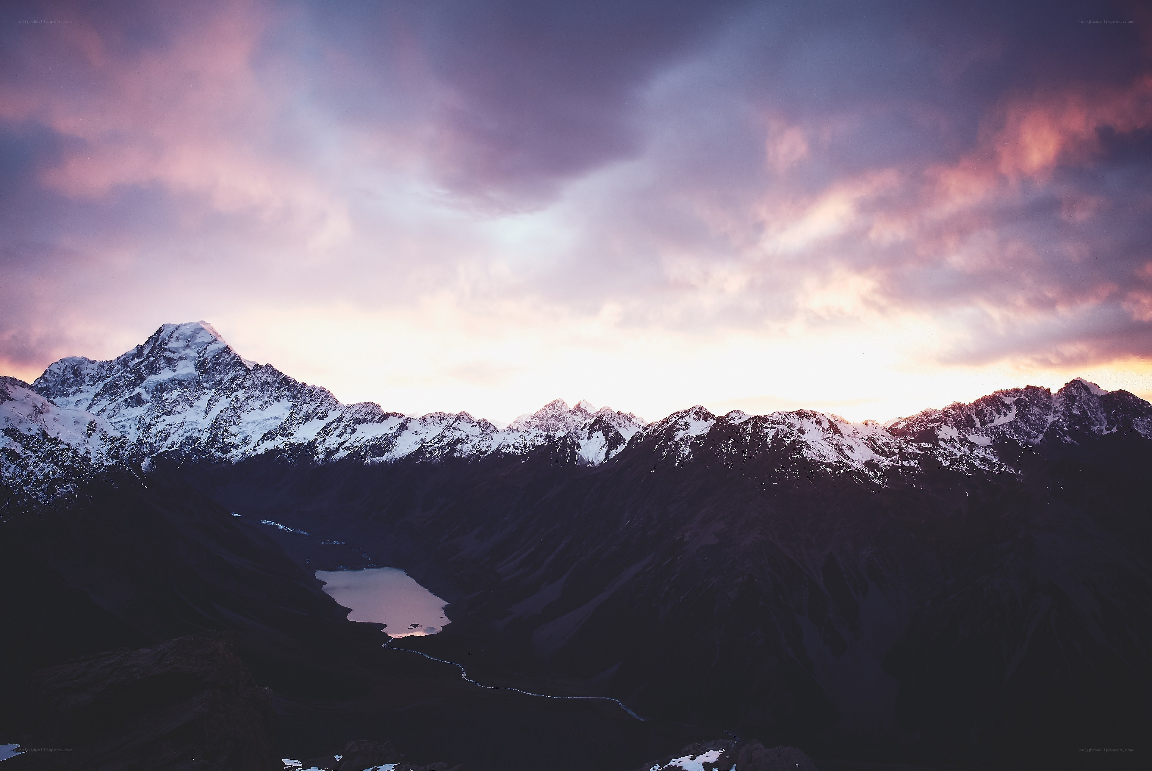 Snow-capped mountains at sunset