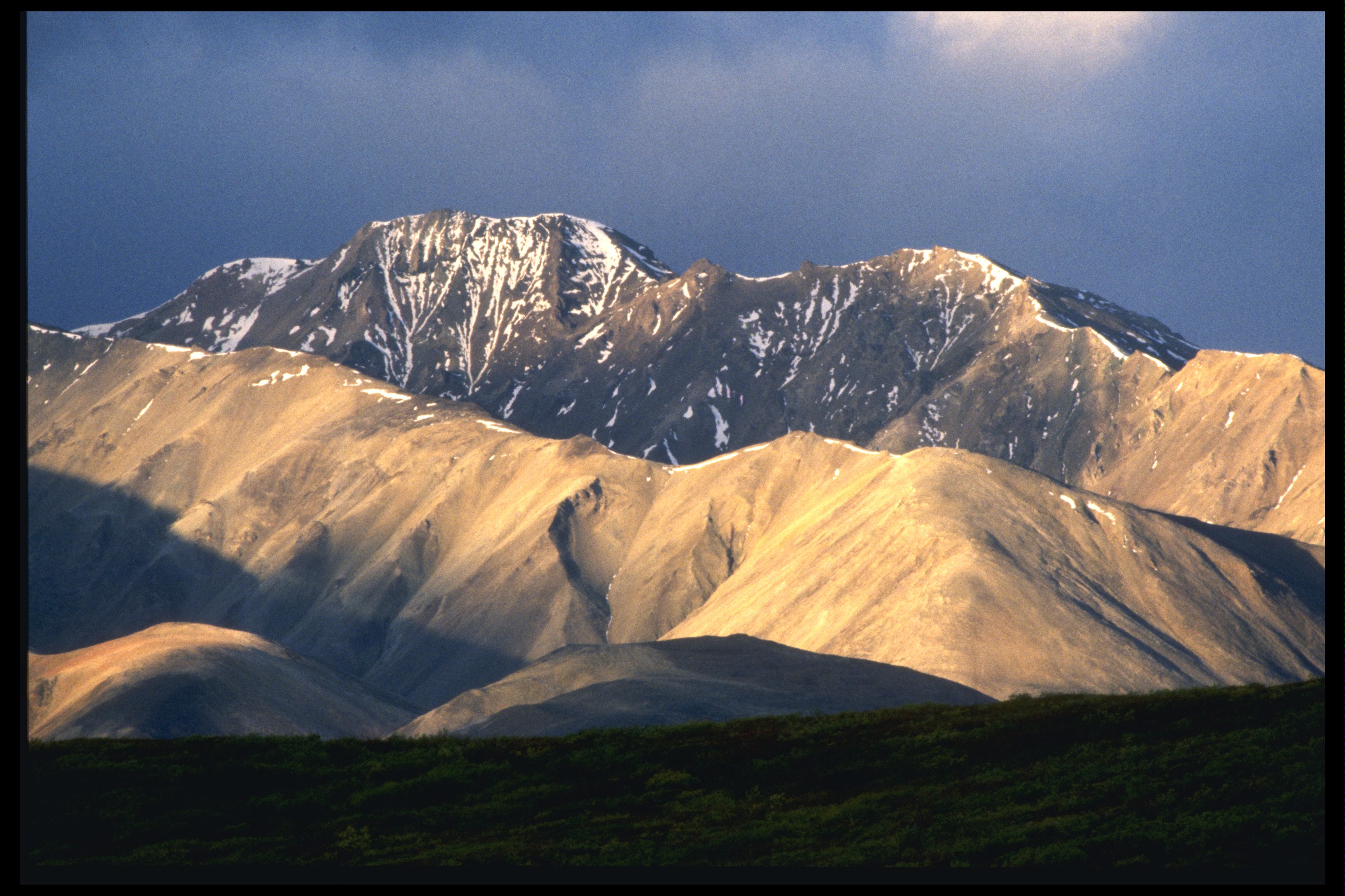 Snow-capped mountains at sunset