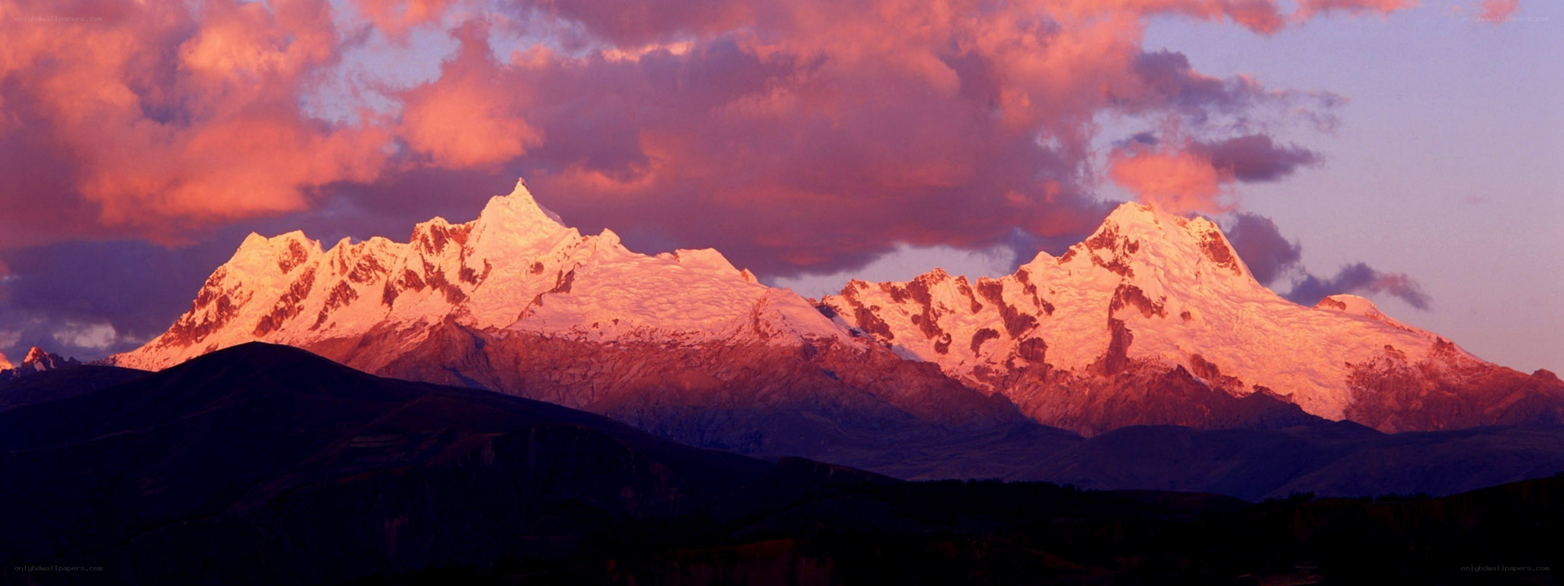 Snow-capped mountains at sunset