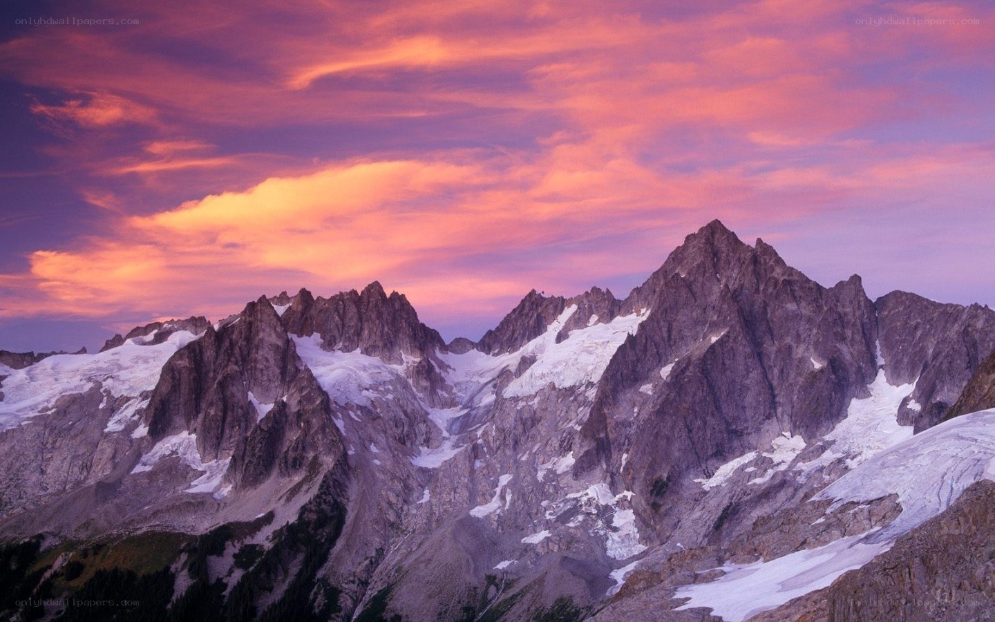 Snow-capped mountains at sunset