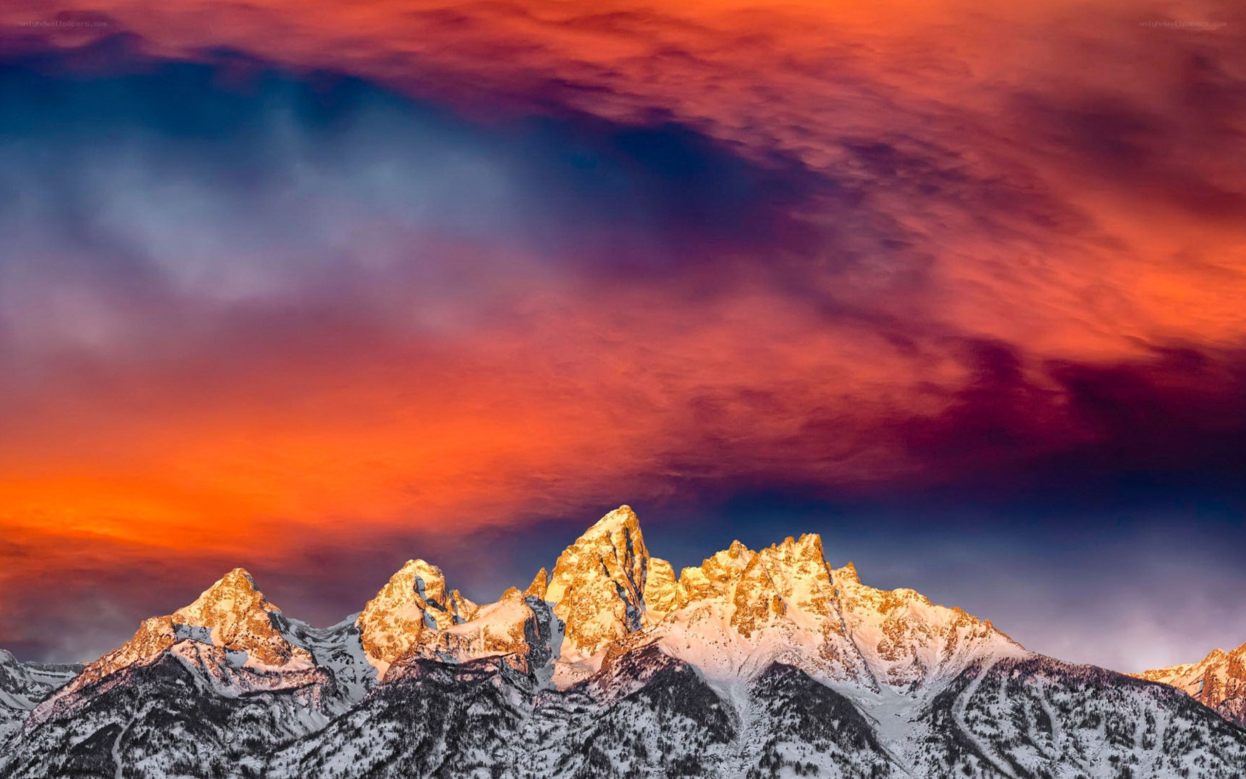 Snow-capped mountains at sunset