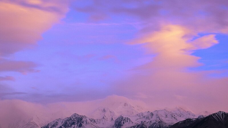 Snow-capped mountains at sunset