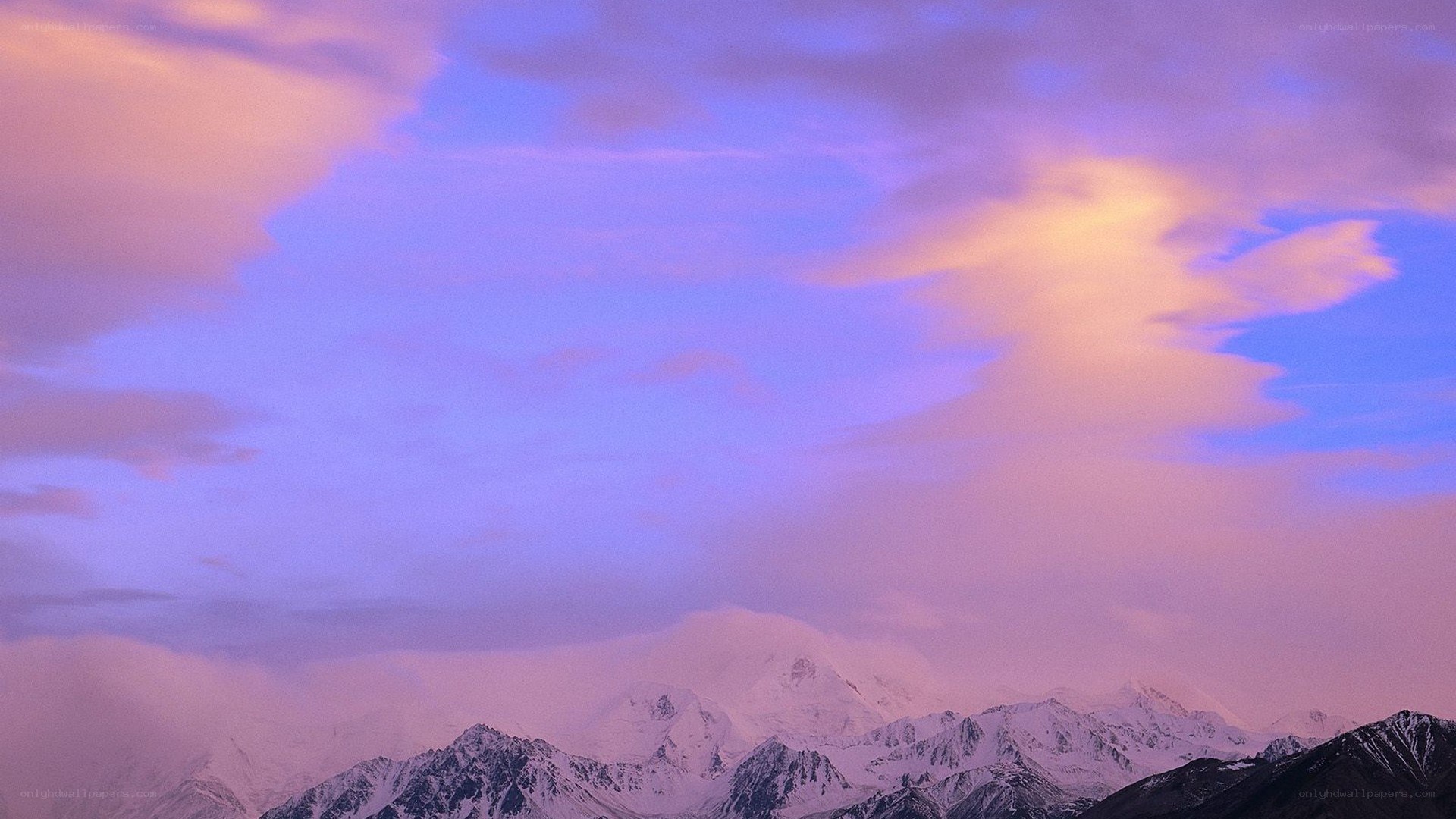 Snow-capped mountains at sunset