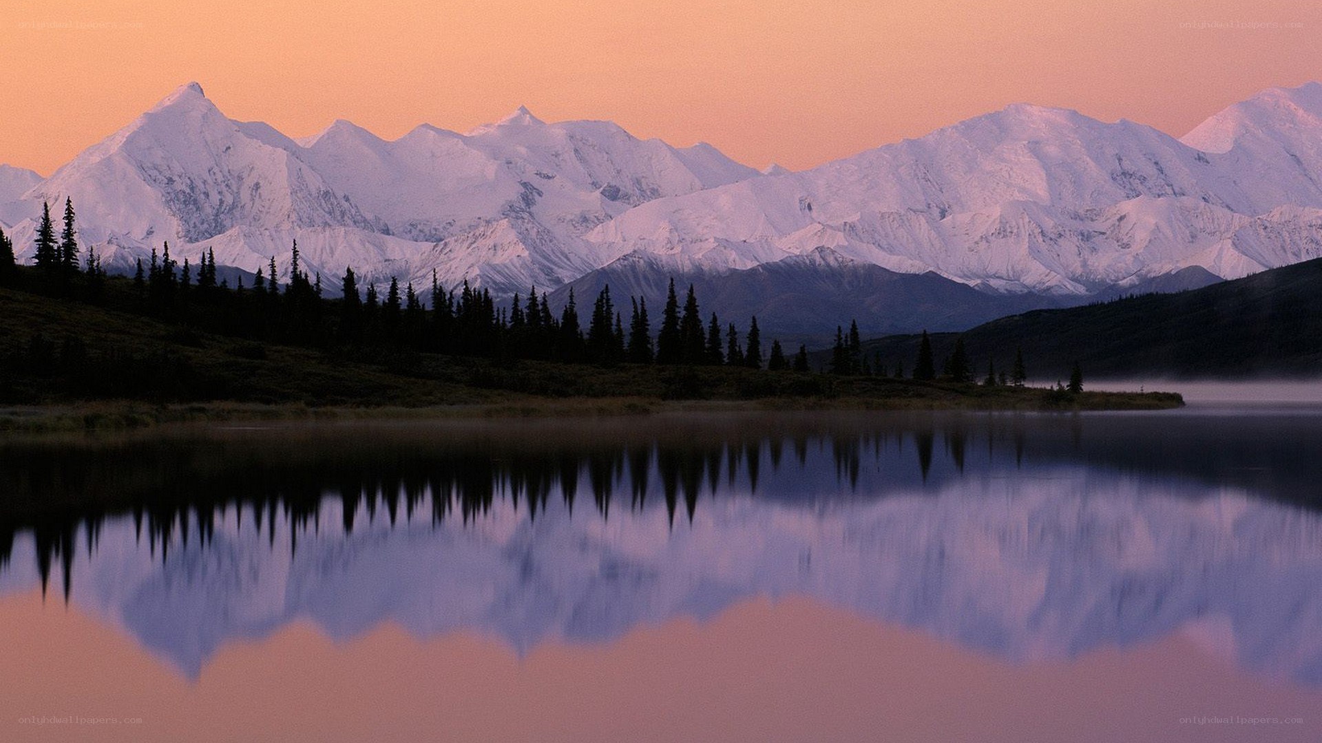 Snow-capped mountains at sunset