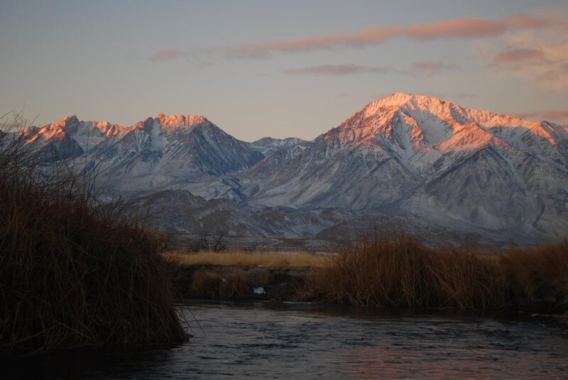 Snow-capped mountains at sunset