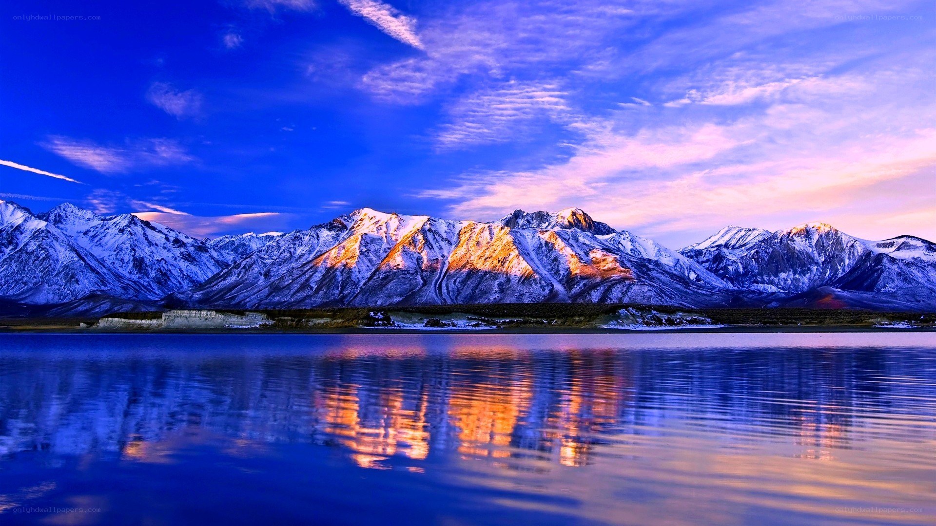 Snow-capped mountains at sunset