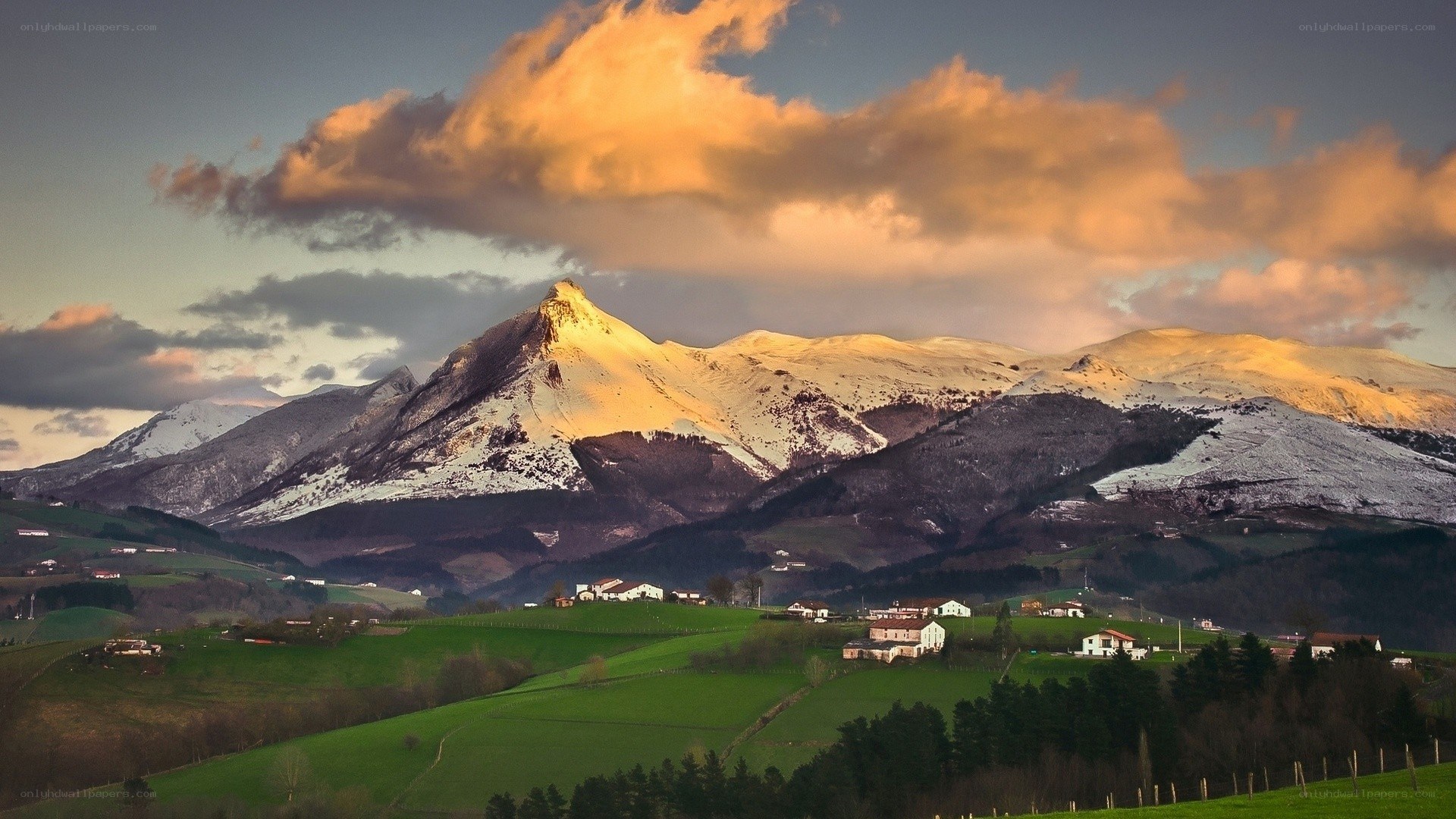 Snow-capped mountains at sunset