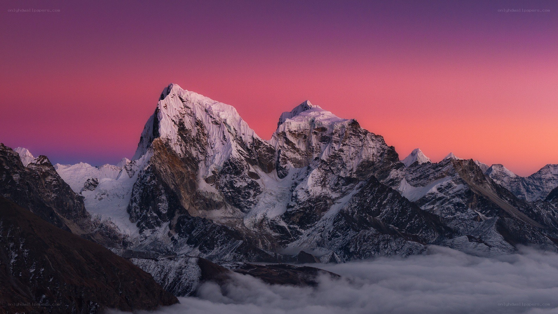 Snow-capped mountains at sunset