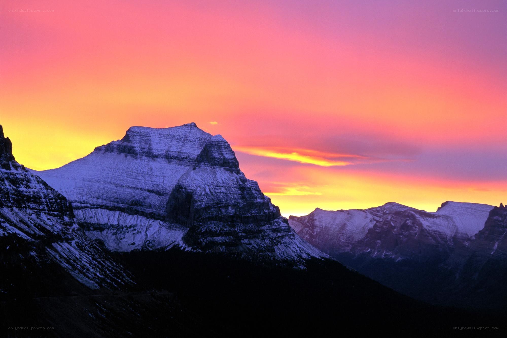Snow-capped mountains at sunset