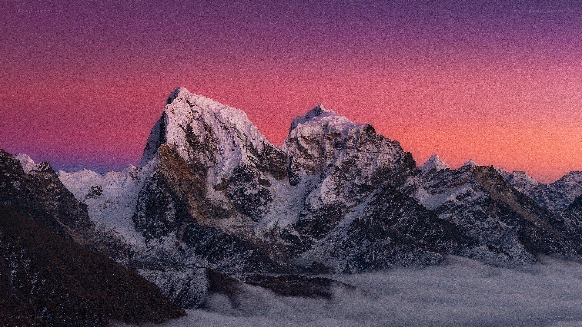 Snow-capped mountains at sunset