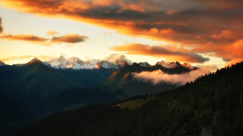 Snow-capped Mountains at Sunset — Orange, Dramatic, Photograph, Clouds, Forest, Valley