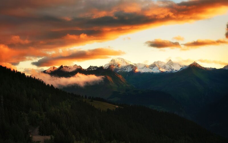 Snow-capped Mountains at Sunset — Orange, Dramatic, Photograph, Clouds, Forests, Valley