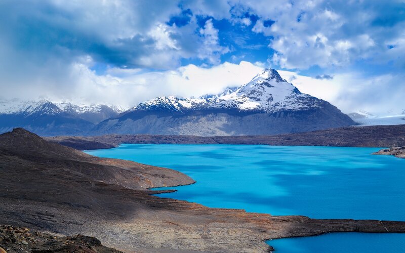 Snow-capped Mountains — Blue, Dramatic, Afternoon, Photograph, Lake, Clouds, Rocky Shore