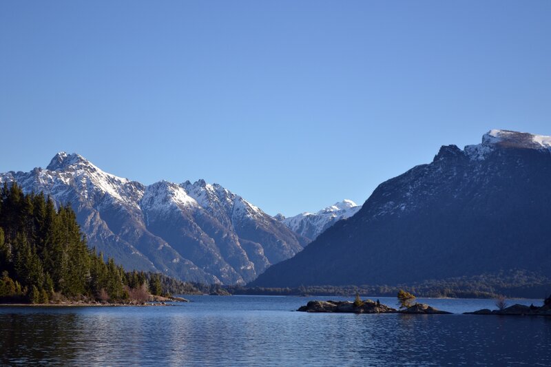 Snow-capped mountains by a lake