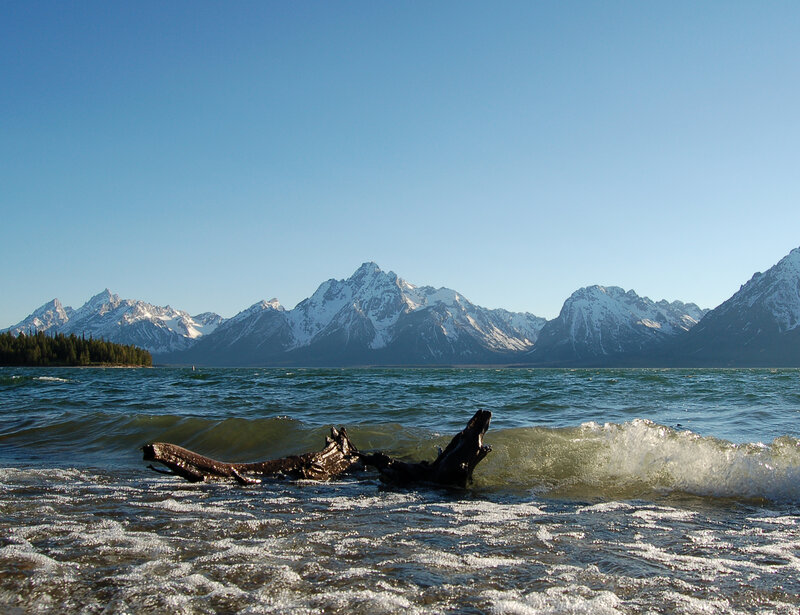 Snow-capped mountains by a lake