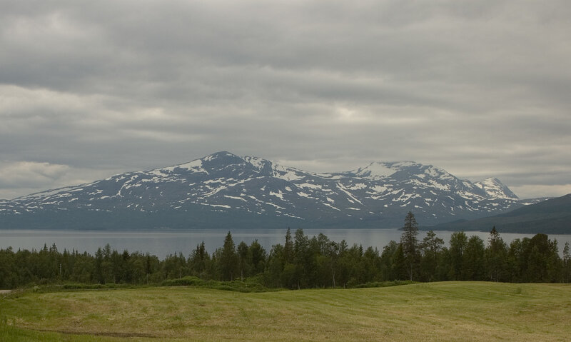 Snow-capped mountains by a lake