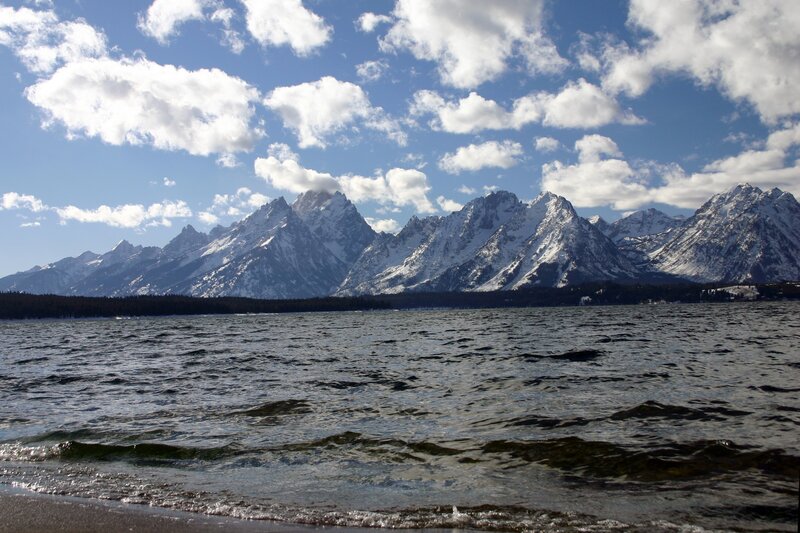 snow-capped mountains by a lake