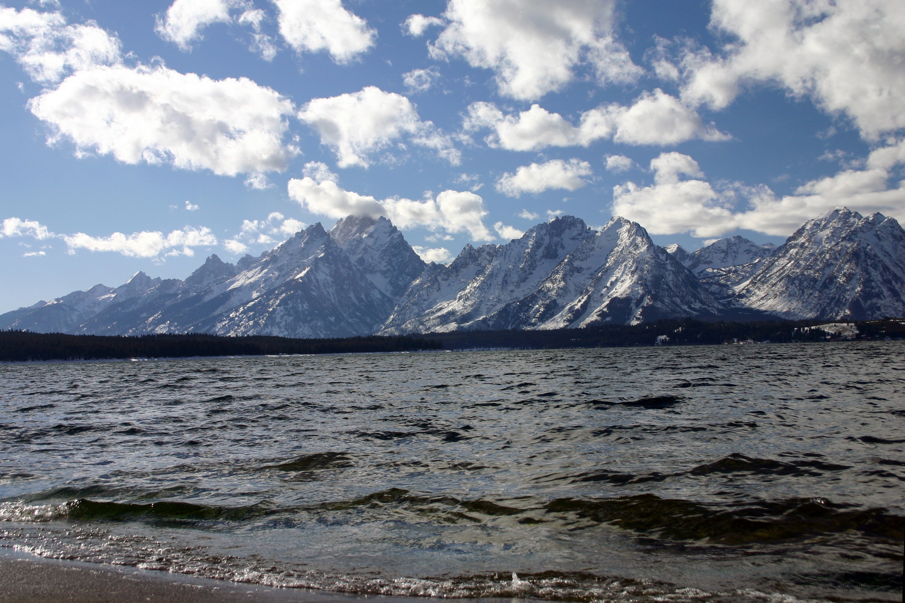 snow-capped mountains by a lake