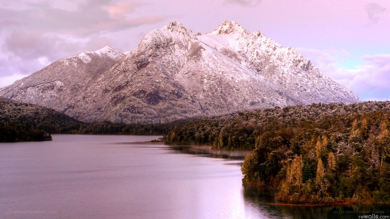 Snow-capped mountains by a lake