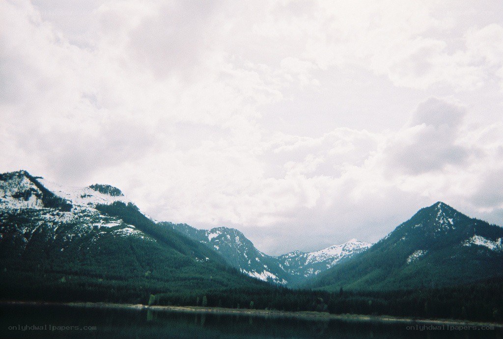 snow-capped mountains by a lake