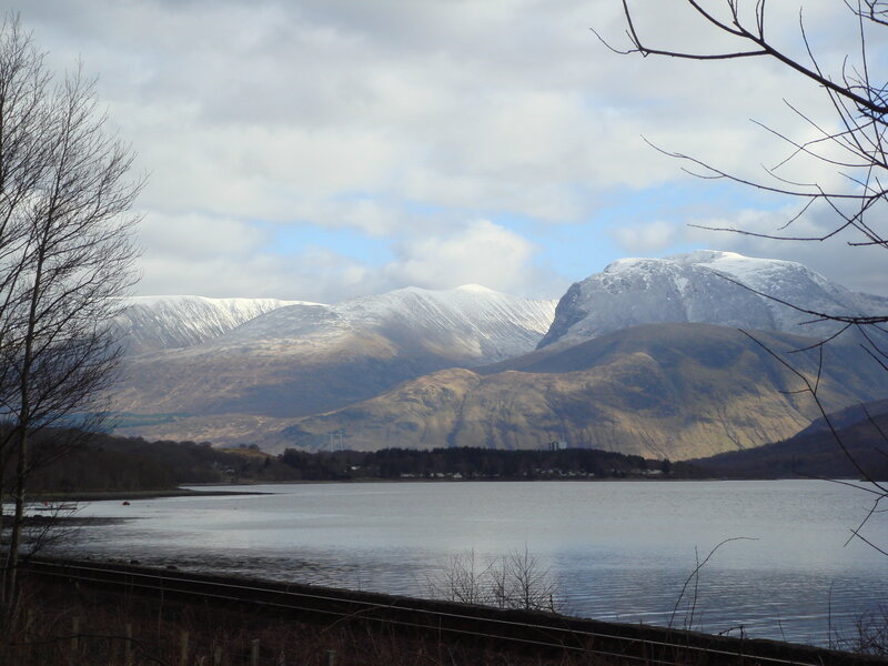 snow-capped mountains by a lake