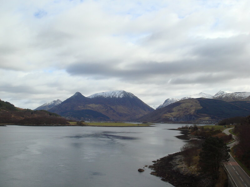 snow-capped mountains by a lake