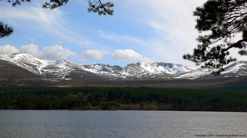 snow-capped mountains by a lake