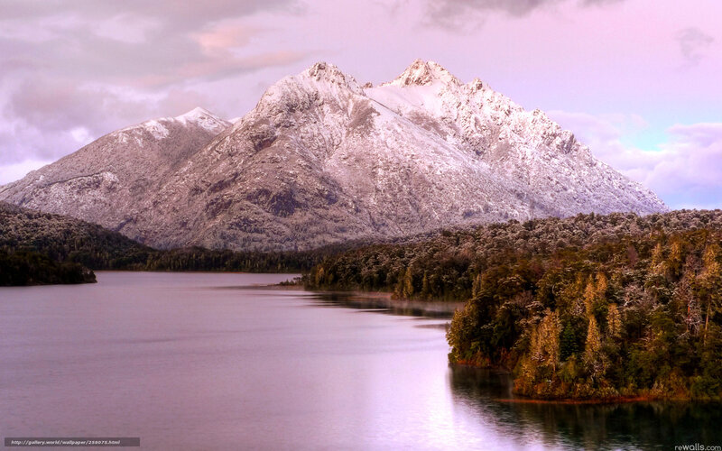 Snow-capped mountains by a lake