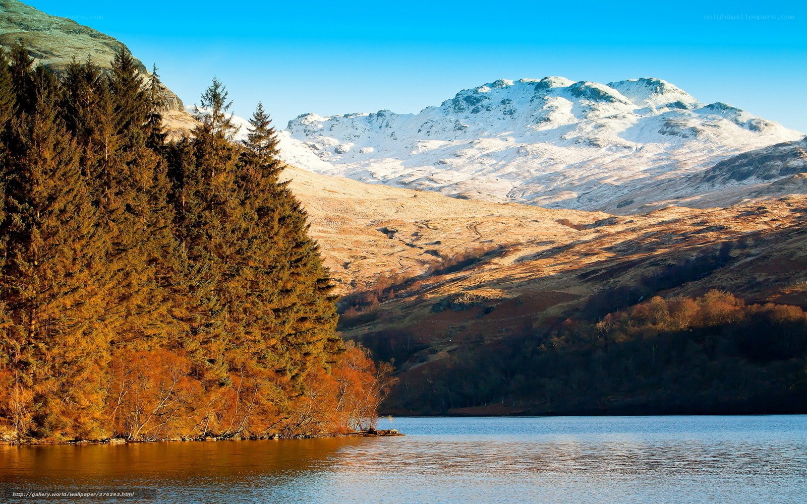 Snow-capped mountains by a lake
