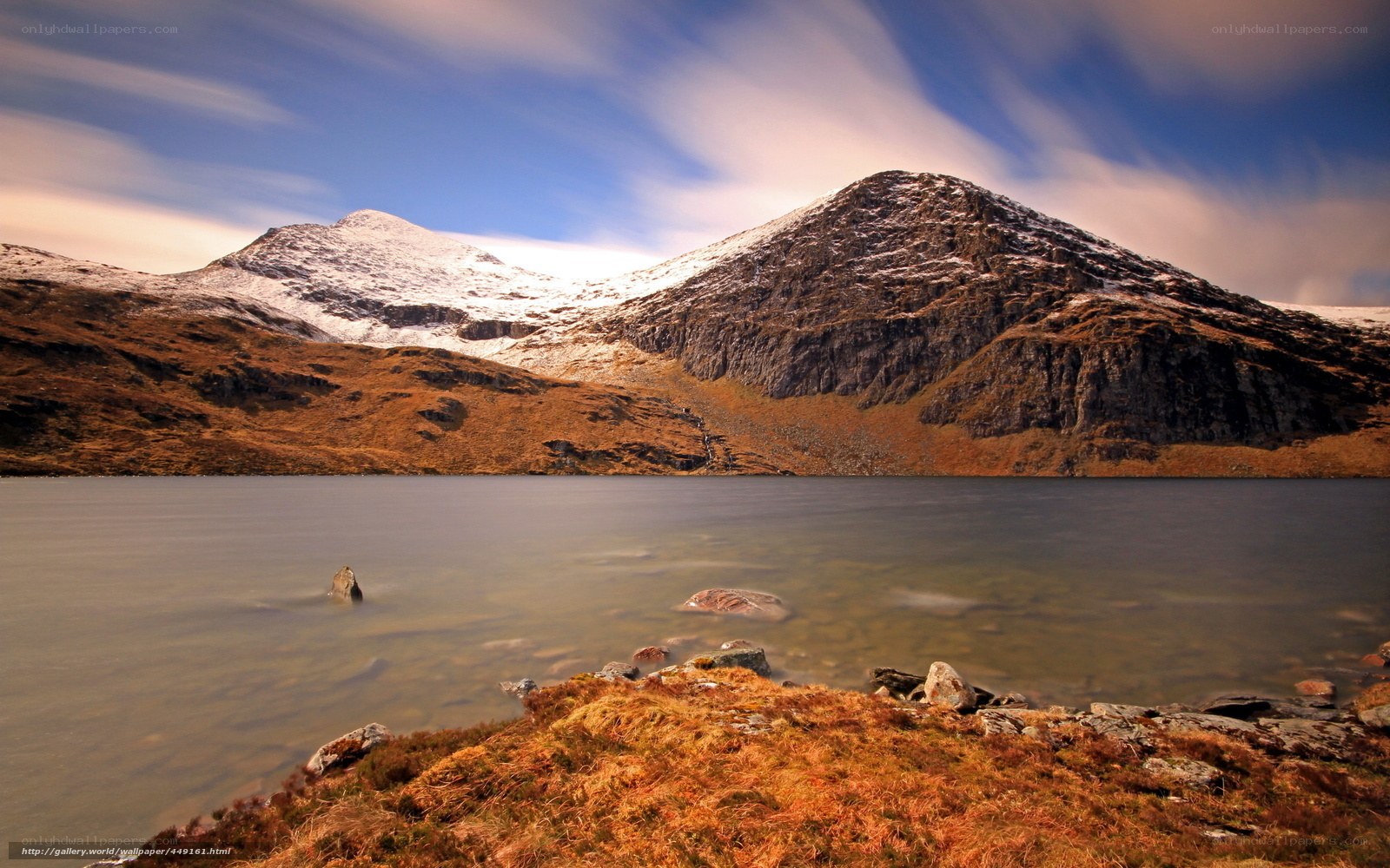 Snow-capped mountains by a lake