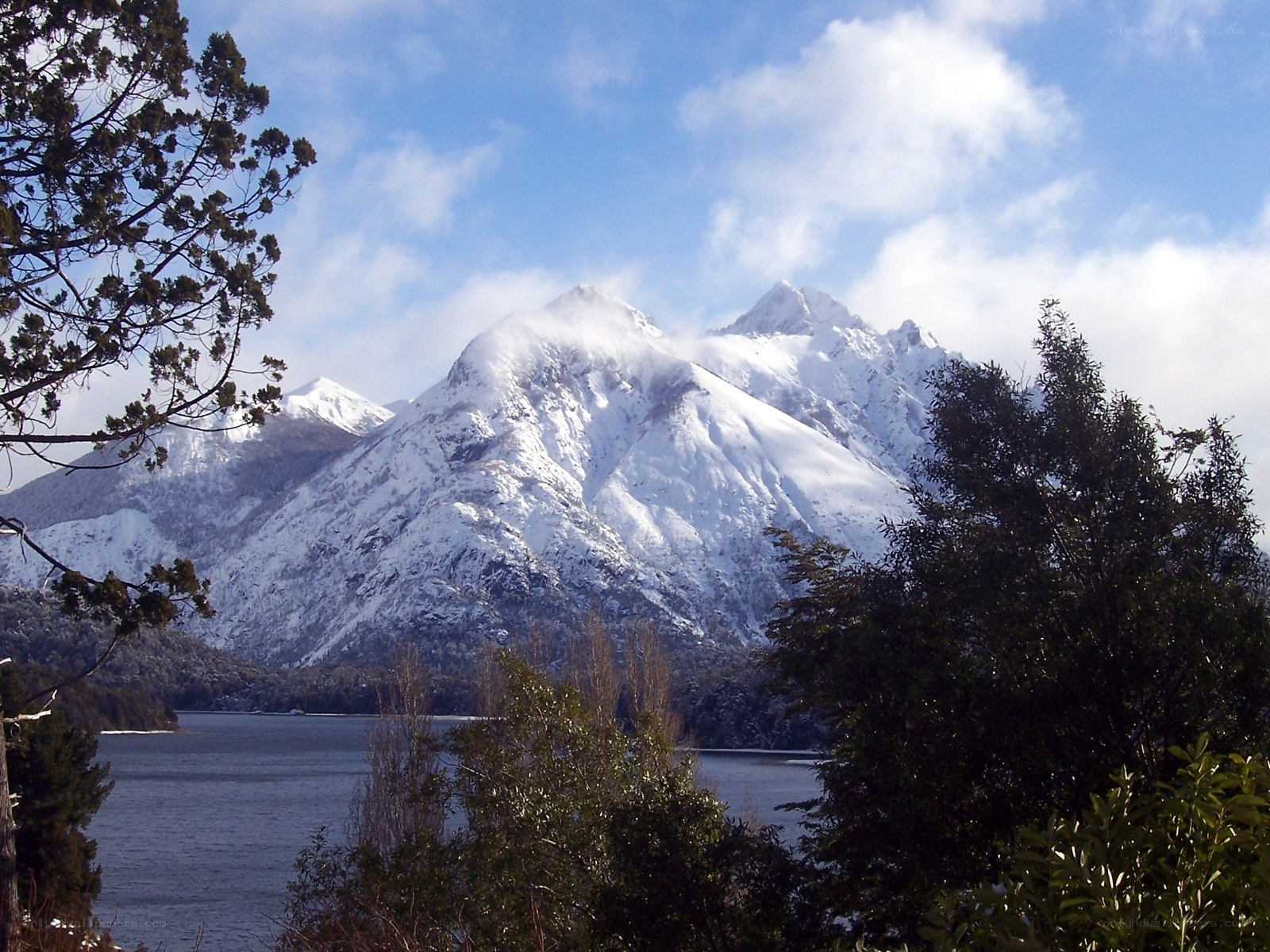 Snow-capped mountains by a lake