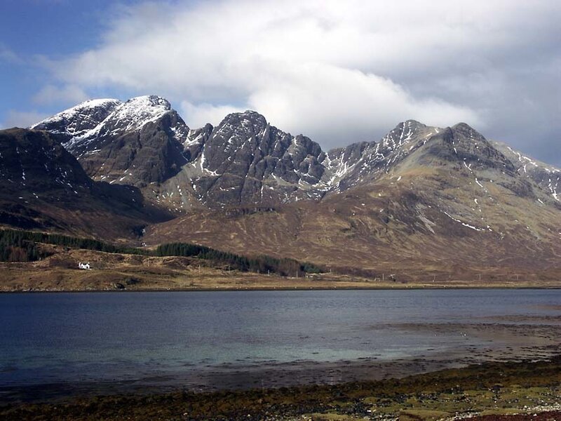 snow-capped mountains by a loch