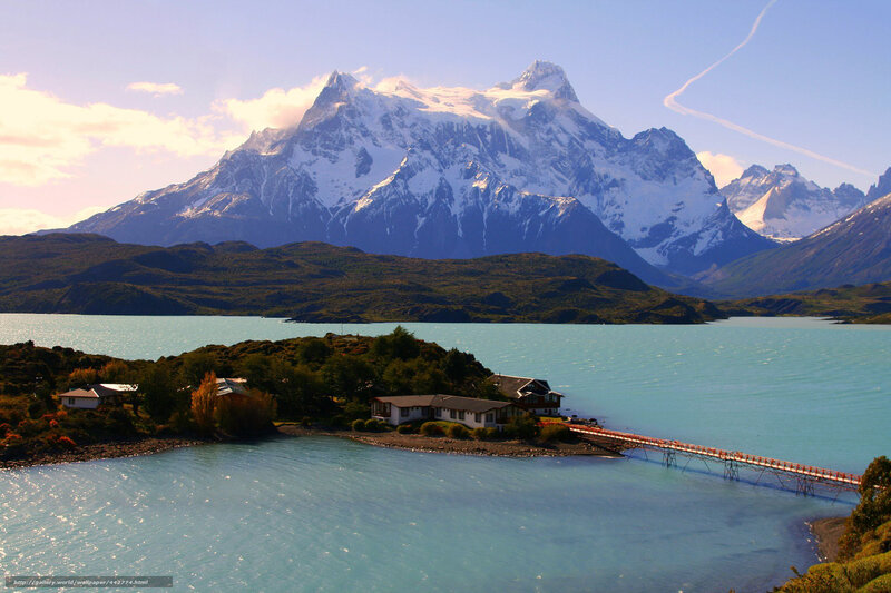 Snow-capped mountains by a turquoise lake