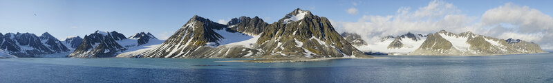 snow-capped mountains by the sea