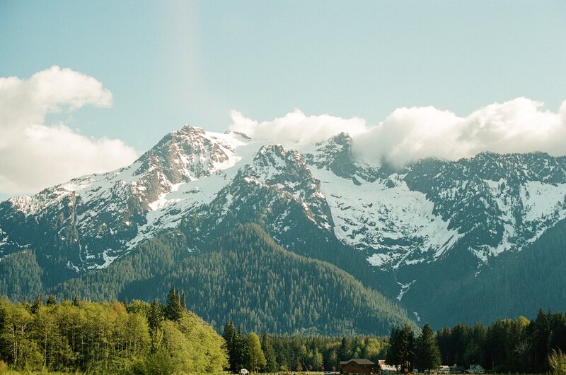 Snow-capped Mountains — Green, Serene, Afternoon, Photograph, Forest, Clouds, Buildings