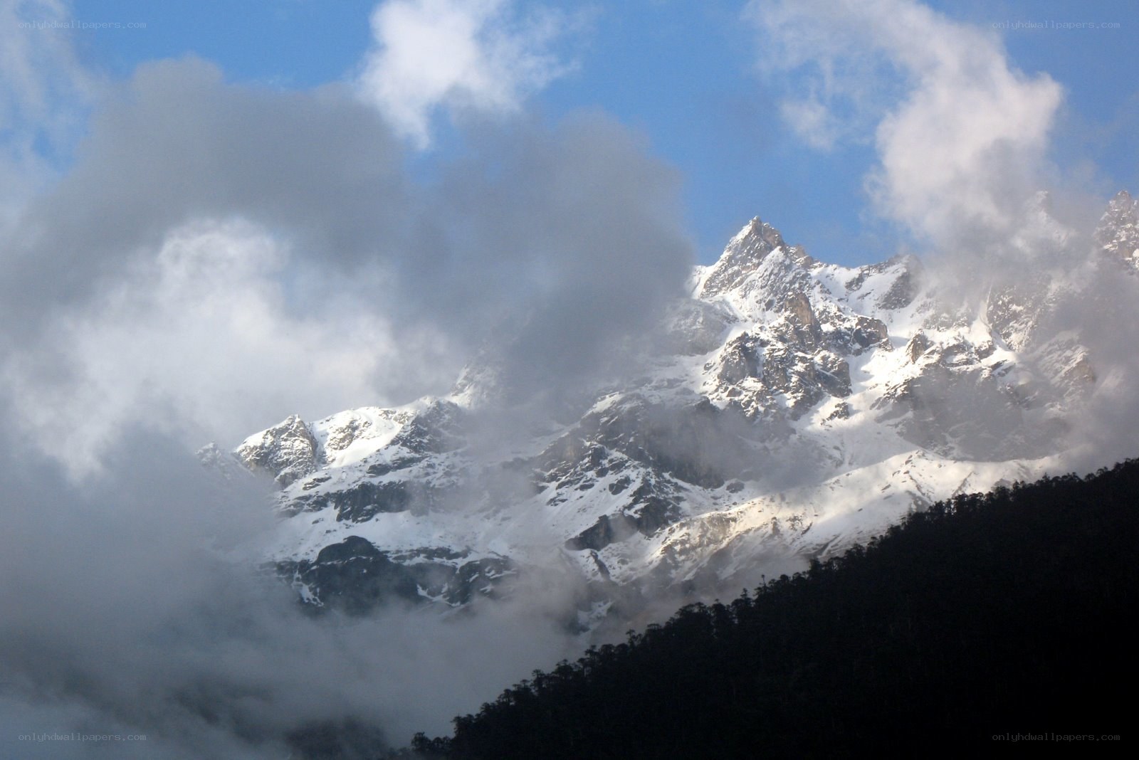 snow-capped mountains in clouds