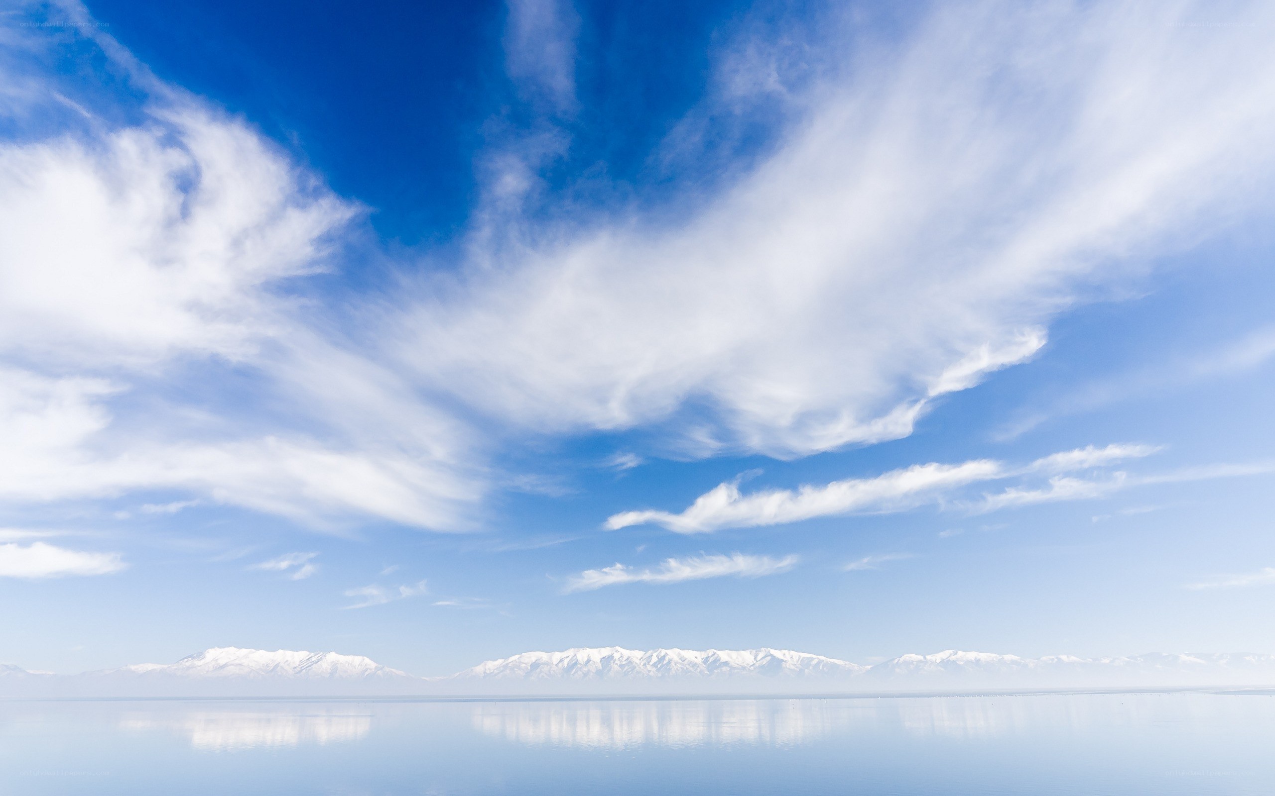 Snow-capped mountains over calm lake