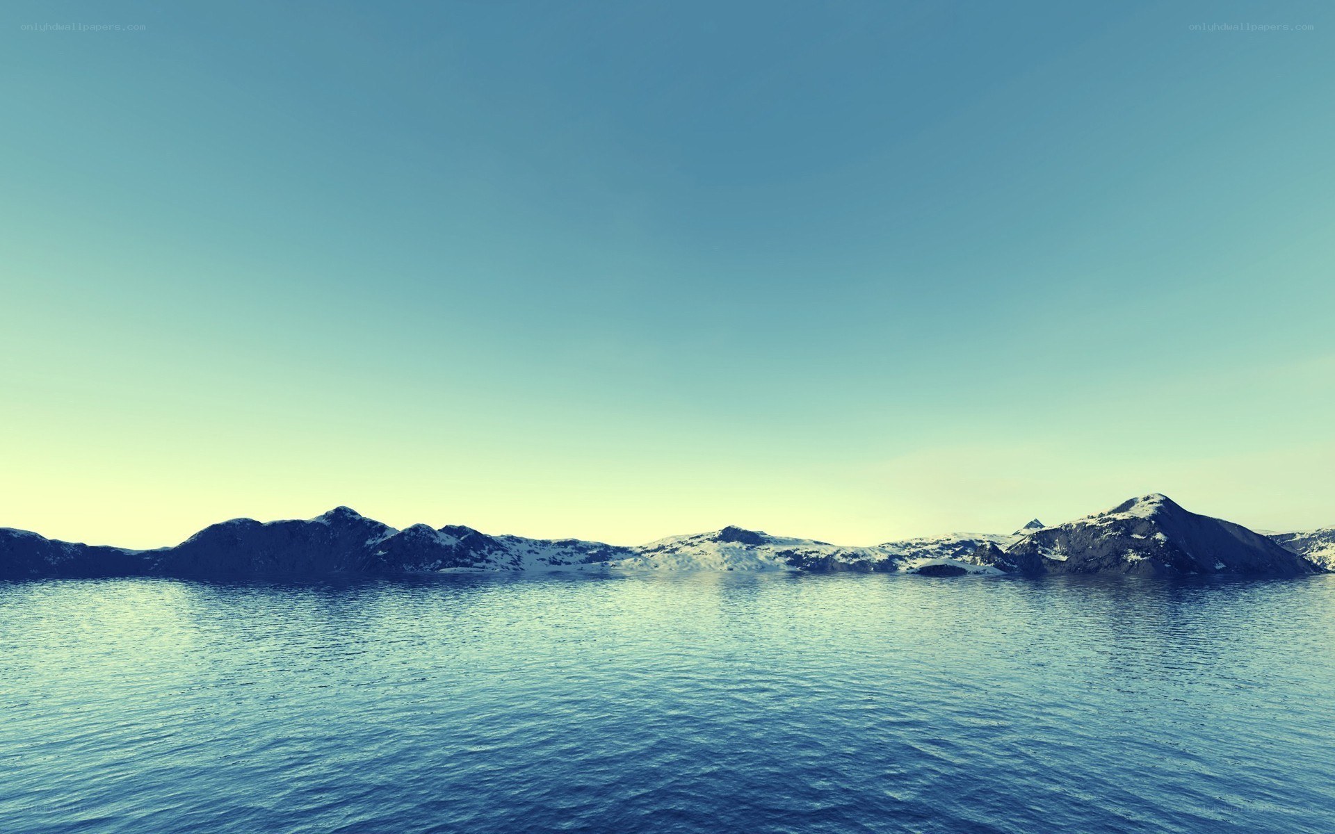 snow-capped mountains over calm water