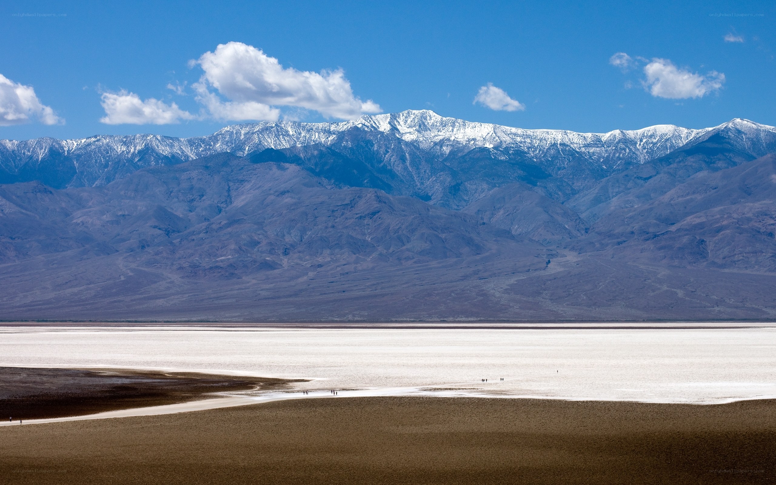 Snow-capped mountains over salt flats